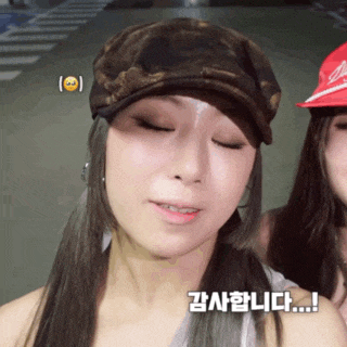 a woman wearing a hat has a smiley face on her face