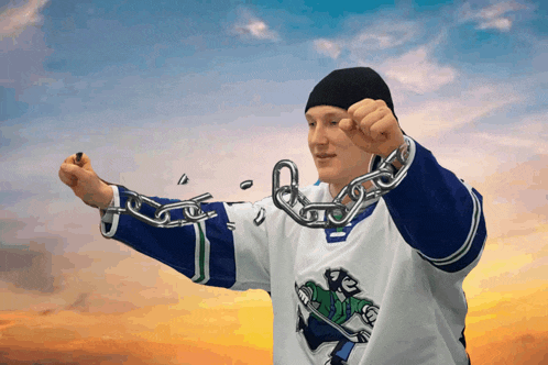 a man in a hockey jersey is holding a chain