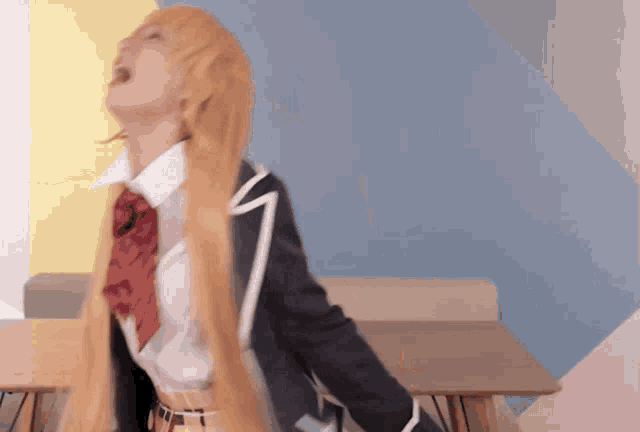 a woman in a school uniform is sitting at a table with her eyes closed