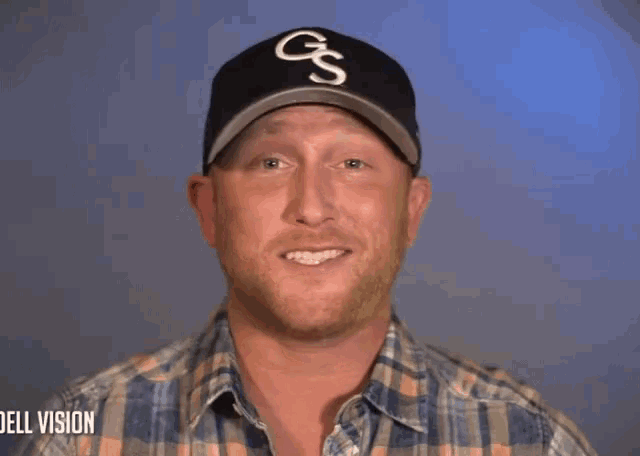 a man wearing a gs hat and a plaid shirt says gonna be a