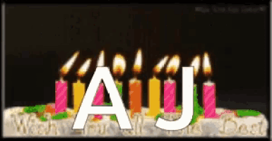 a picture of a birthday cake with candles and the name aj