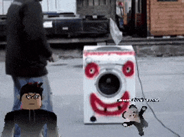 a man standing next to a washing machine with a face painted on it