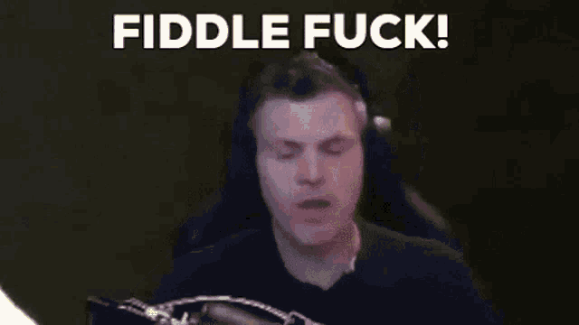 a man wearing headphones is sitting in front of a microphone with the words `` fiddle fuck '' written above him .