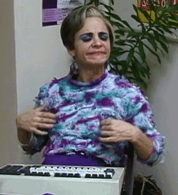 a woman in a floral shirt is sitting in front of a white keyboard