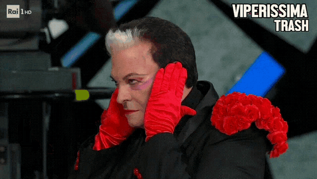 a man wearing red gloves and red roses has the words viperissima trash written above him