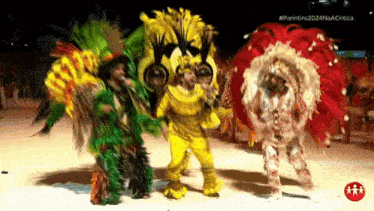 a group of people in colorful costumes are dancing on a stage ..