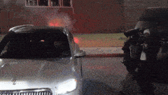 a silver mercedes is parked on the side of the road