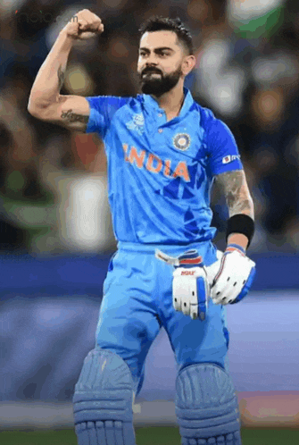 a cricket player wearing a blue jersey that says india on it