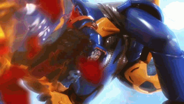 a close up of a blue and yellow robot with a s on its chest