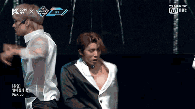 two men are dancing on a stage and the words we are k pop are on the bottom
