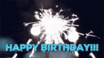 a happy birthday greeting card with sparklers in the foreground