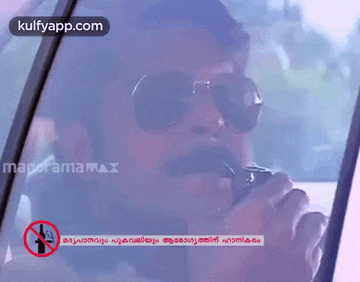 a man wearing sunglasses and a mustache is talking on a walkie talkie in a car ..