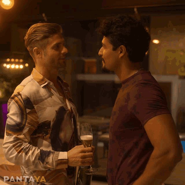 two men standing next to each other with pantaya on the bottom right