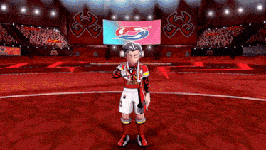 a man in a red jersey with the word rugby on it stands in a stadium