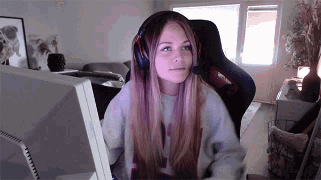 a woman wearing headphones and a sweater with the letter n on it