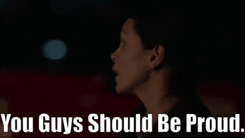 a woman in a dark room with the words " you guys should be proud " on the bottom