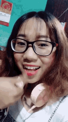 a girl wearing glasses and a shirt that says nicenicemice