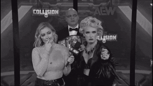 two women standing in front of a sign that says aew