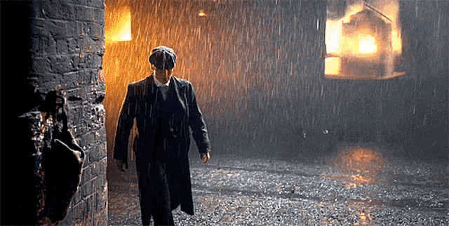 a man in a suit walking in the rain