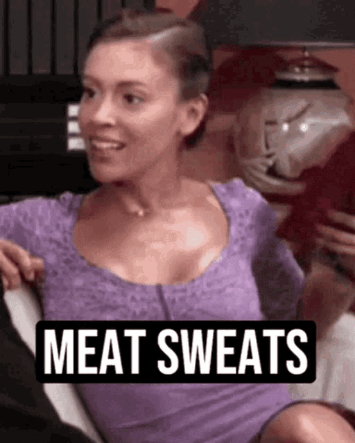 a woman in a purple shirt with the words meat sweats on the bottom