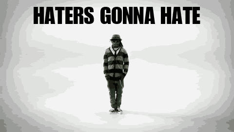 a man is standing in front of a white background with the words haters gonna hate written on it