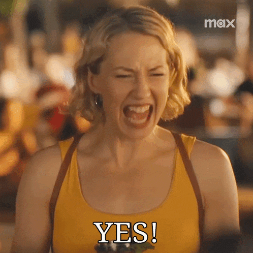a woman in a yellow tank top is screaming and saying " yes "