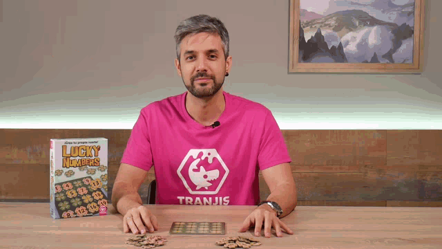 a man wearing a pink shirt with tranjis on it