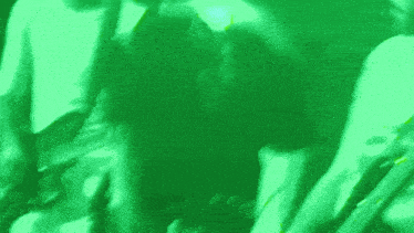 a person is playing a guitar in a green background