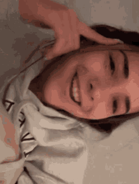 a close up of a woman 's face with her hand on her head