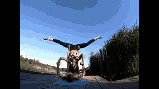 a man and a woman are doing a yoga pose together
