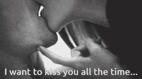 a black and white photo of a man and woman kissing with the caption " i want to kiss you all the time ... "