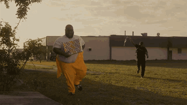 a man wearing a shirt that says ' freedom ' on it is running in a field