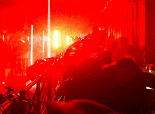 a red light is shining on a black object