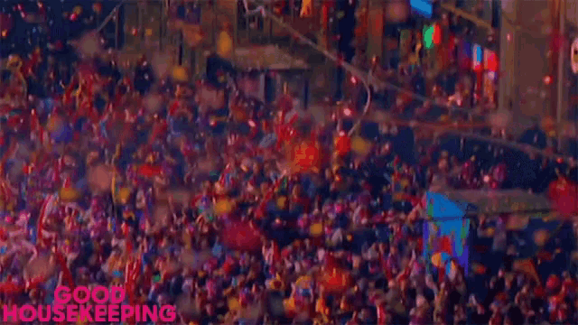 a crowd of people are gathered in a stadium with confetti falling and the words good housekeeping written on the bottom