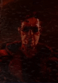a close up of a person 's face with a red background .