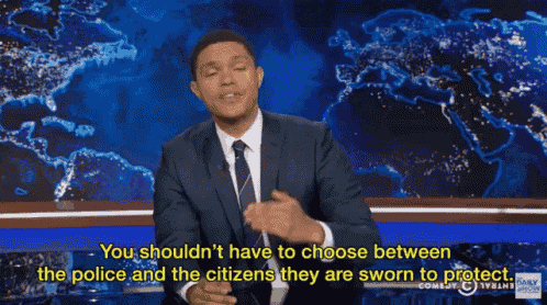 a man in a suit and tie says you shouldn 't have to choose between the police and citizens