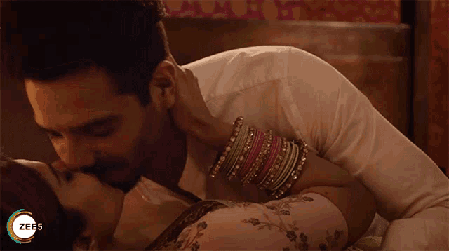 a man kissing a woman on the cheek with a zee5 logo in the corner