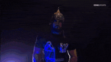 a man wearing a knight 's helmet and a shirt that says ' nv ' on it