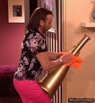a man in a floral shirt and pink pants is holding a megaphone with the words mejores chops above him