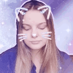 a woman with cat ears on her head looks down with her eyes closed