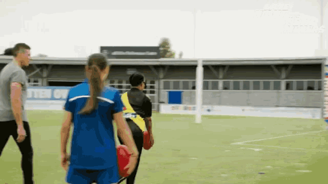 a group of people on a soccer field with a sign in the background that says ' soccer '