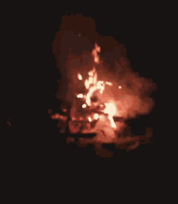 a fire is burning in the dark with a lot of flames