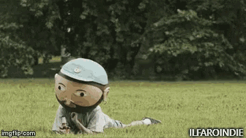 a cartoon character with a beard is laying in the grass .