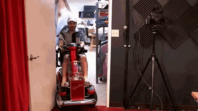 a man is riding a mobility scooter that says gatsby