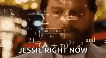a man with a beard is wearing headphones and looking at a screen with mathematical equations .