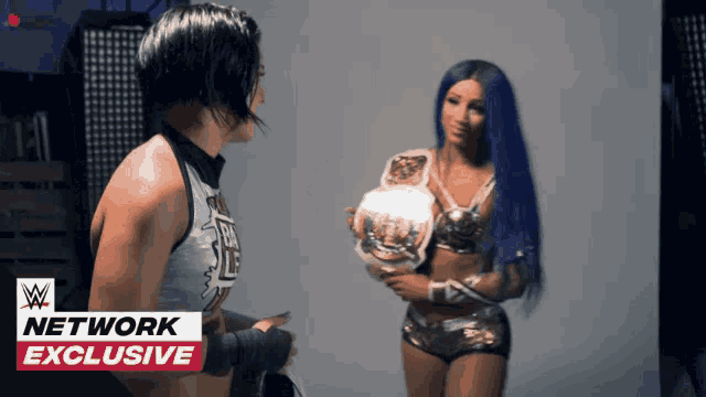 two women are standing next to each other with the words network exclusive on the bottom left