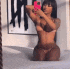 a woman in a bikini is taking a picture of herself in the mirror .