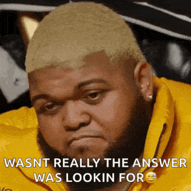 a man with a beard wearing a yellow jacket says wasnt really the answer was lookin for .