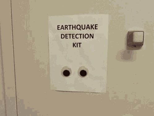 a sign that says earthquake detection kit with googly eyes on it .