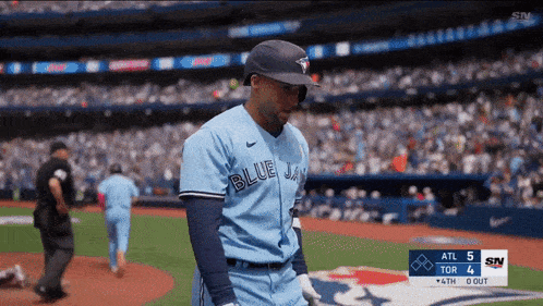 a blue jays player walks off the field during a game